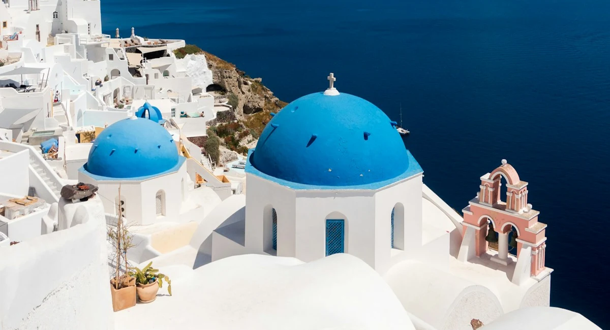 Bright blue domes and white buildings overlooking the Aegean Sea in Santorini, Greece